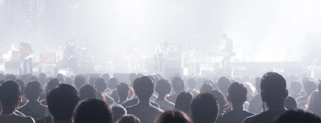 image of a band playing in front of crowd.