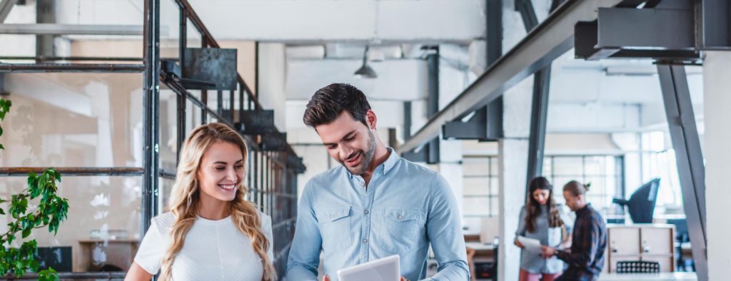 workers looking at paper in office setting