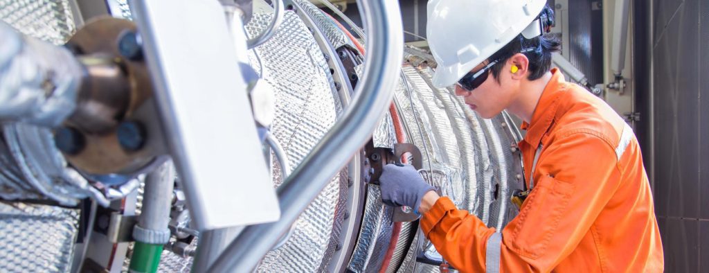 worker checking air duct